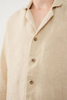 Close-Up of Linen Fabric Texture and Buttons on Beige Shirt