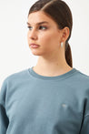 Woman wearing the  Ra Denim-Vita Crop Women's Sweatshirt in Blue