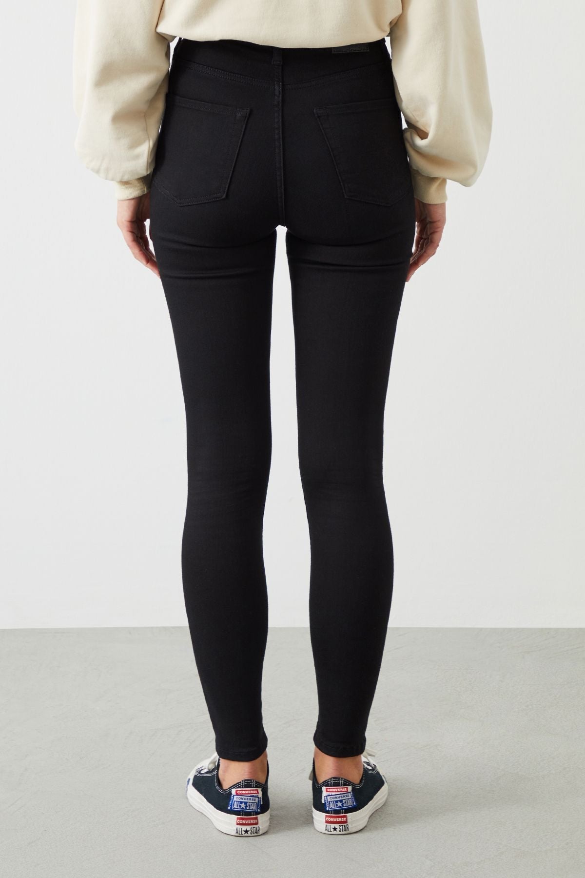 Back view of ZEL Stay Black Jeans from Ra Denim Women's Collection, showcasing their sleek silhouette and unfading black color