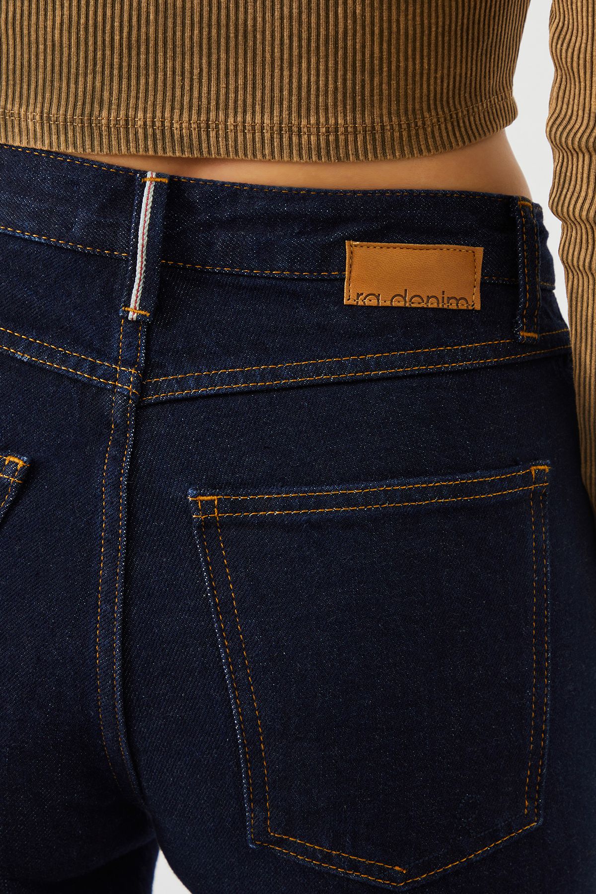 Detailed view of the back pockets on MIRA Boyfriend Fit Dark Blue Selvedge Women's Jeans, featuring intricate stitching.