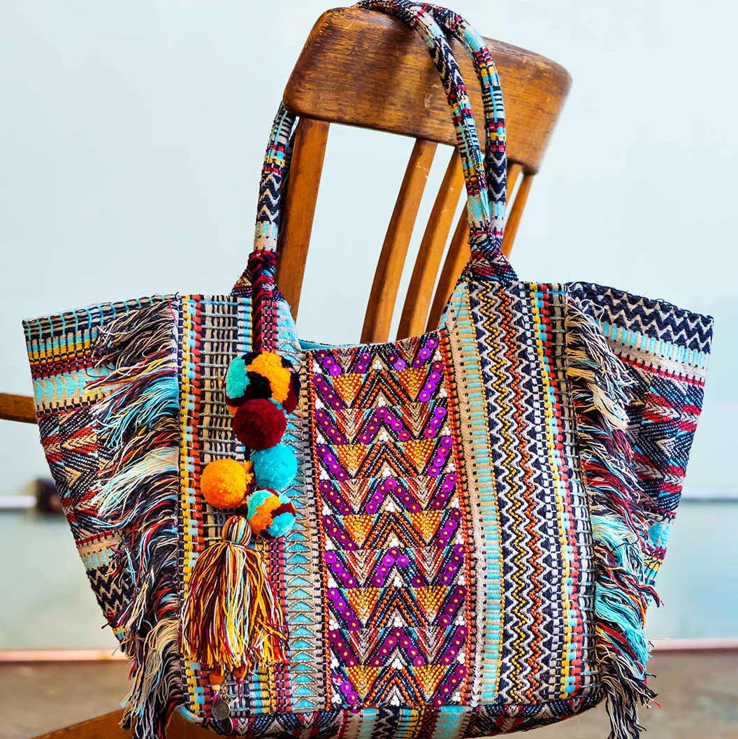 A bold mix of turquoise, lilac, and orange meets exquisite beadwork and sequins in the handcrafted Smitten Lali Bag—your go-to statement accessory